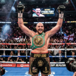 Tyson Fury with championship belt in boxing ring celebrating victory, Gypsy King in heavyweight division boxing.